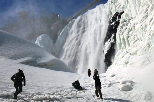 people at the fozen Montmorency Falls in Quebec